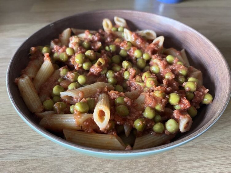 Penne pasta with corned beef and peas mixed through it. 
