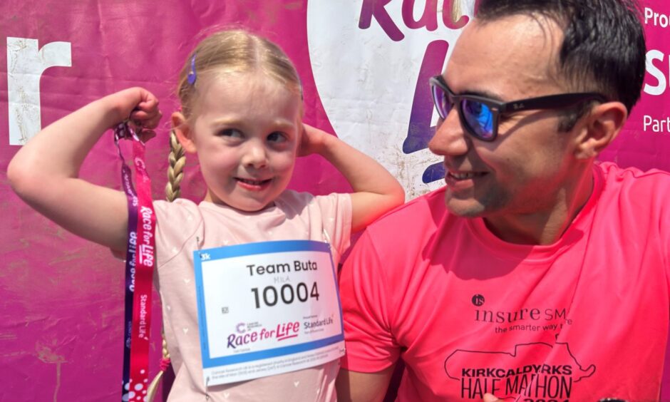 Four-year-old Mila Buta with her medal