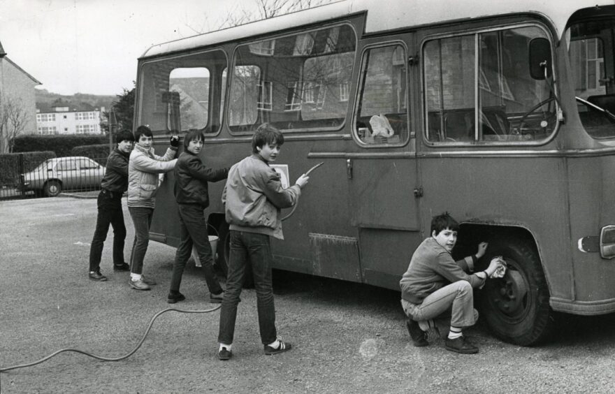 The boys washing the side of the bus in March 1983