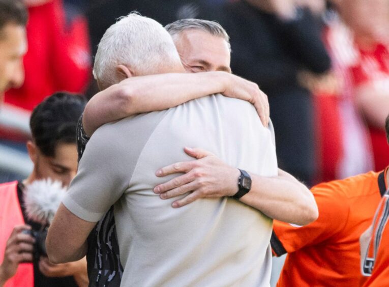 Jim Goodwin embraces long-time assistant manager, Lee Sharp, who has worked with him since the Alloa days.