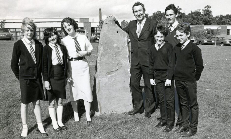 Rector Peter Murphy and pupils beside the school monolith in August 1985. Image: DC Thomson.