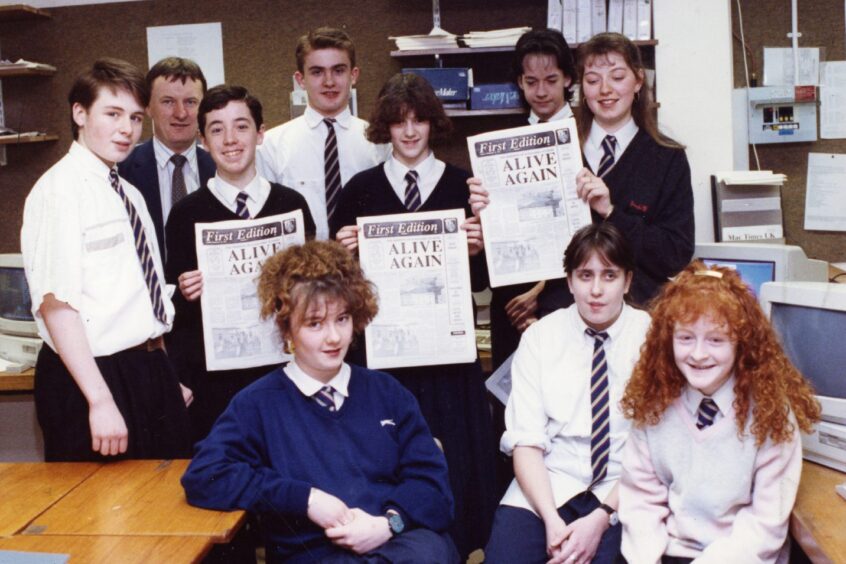 Whitfield High School pupils and staff with copies of their newspaper. 