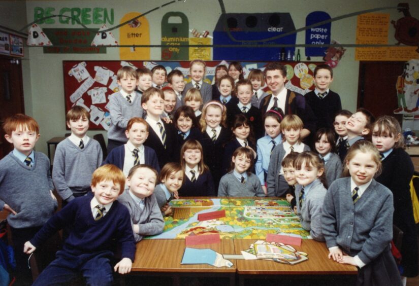 Charleston Primary School pupils gathered around a table with the environmental game.