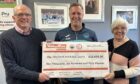 Stirling Albion manager Alan Maybury handing over the lottery winners cheque to Margaret and Robert Lawrie.