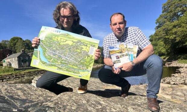 Explore Scotland director Marius Bezuidenhout and illustrator Dylan Gibson (with map) on the banks of the river Tummel. Image: Heartland Media/PR