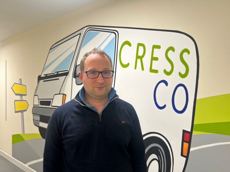 Joe Wall beside The Cress Company Logo