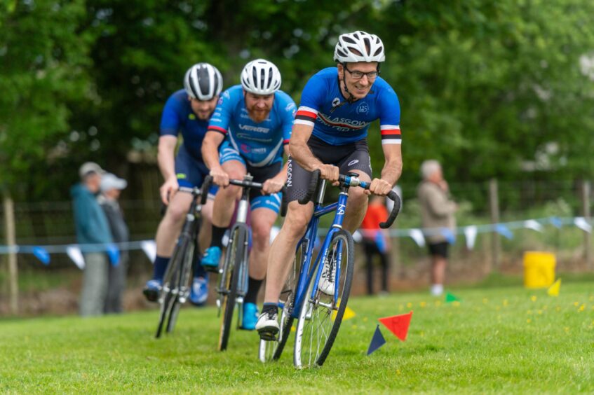Three men compete in a cycling race