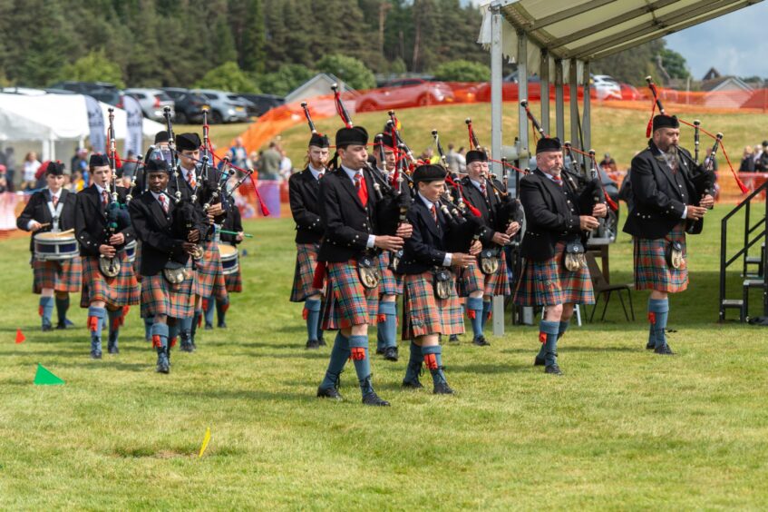 A pipe band arrives at Blackford Highland Games
