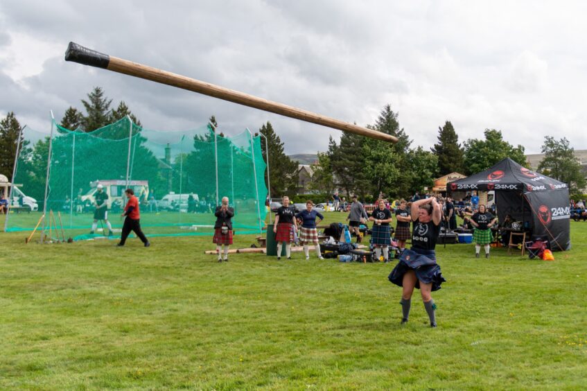 Rebecca Maeule competes in the caber tossing competition.