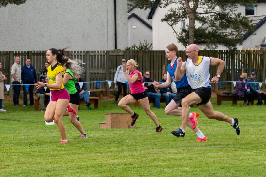 Adults running a race at Blackford Highland Games