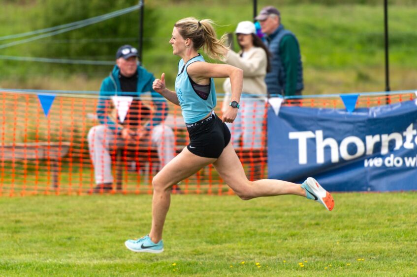 A woman running in a one-mile race.