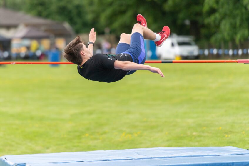 Stuart Whiteford clears the bar in the high jump.