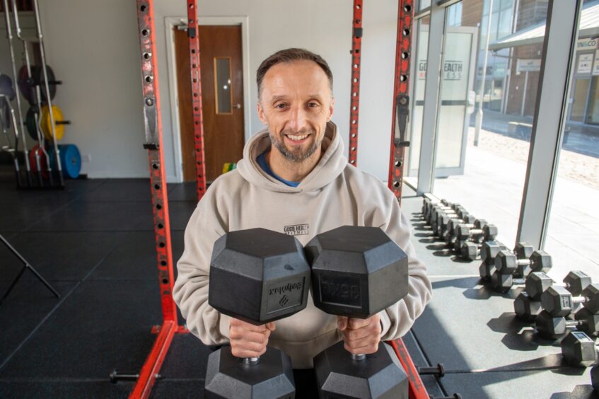 Good Health and Fitness owner Stephen with dumbells