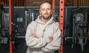 Stephen Dale leaning against equipment at Good Health and Fitness