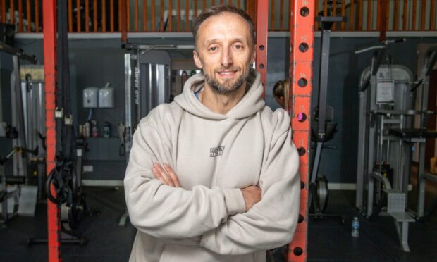 Stephen Dale leaning against equipment at Good Health and Fitness