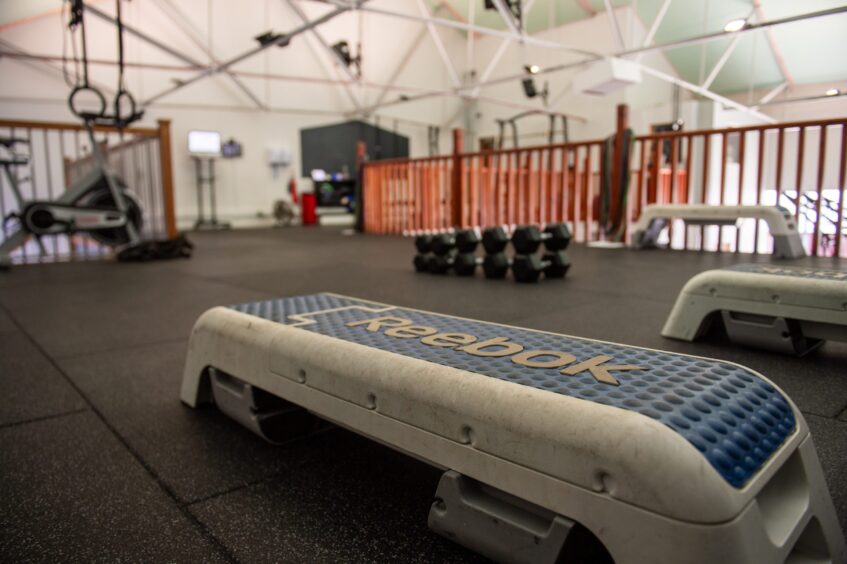 Inside Good Health and Fitness gym - showing weights and benches