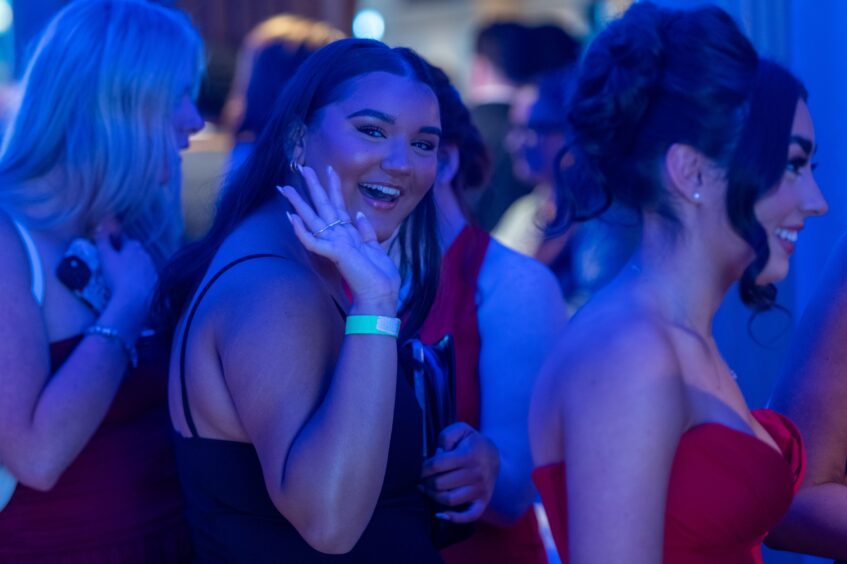 A girl waves to the camera at the event.