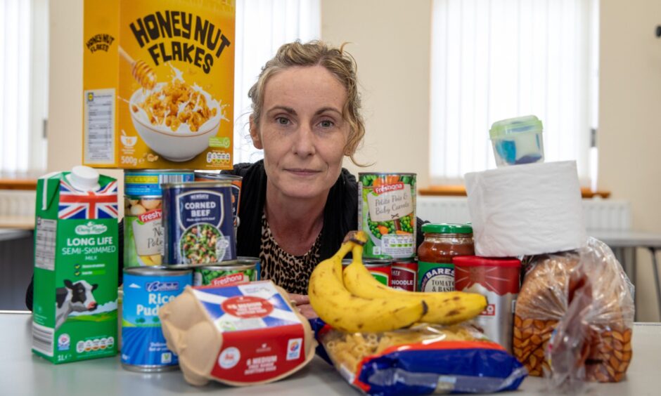Cheryl with the contents of her food parcel.