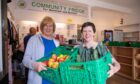 Volunteers Dorothy Culloth (left) and Barbara Lindsey with some of the food available to community fridge clients. Image: Kenny Smith/DC Thomson