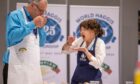 Morag Lindsay putting haggis in mouth while Jon Wilkin sniffs plate of food