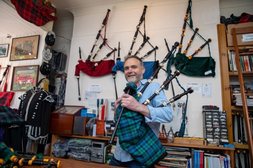 Bagpipe Maker Alan Waldron holding one of the shops bagpipes. Image: Kenny Smith/DC Thomson