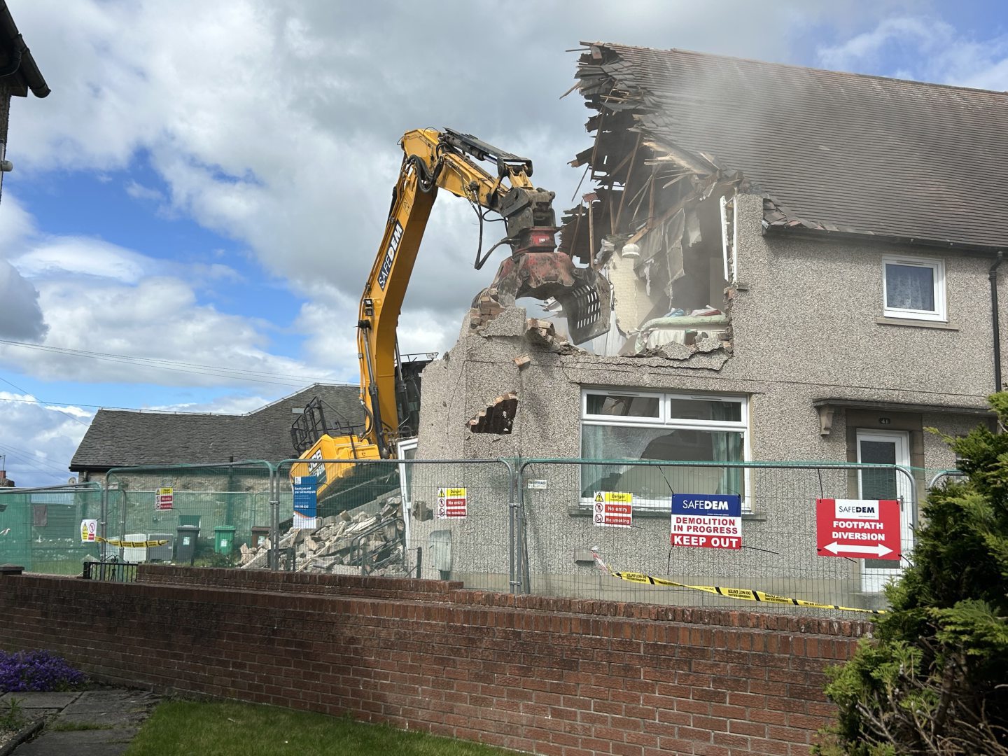 The first house being torn down. 