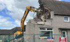 Brickwork being torn down.