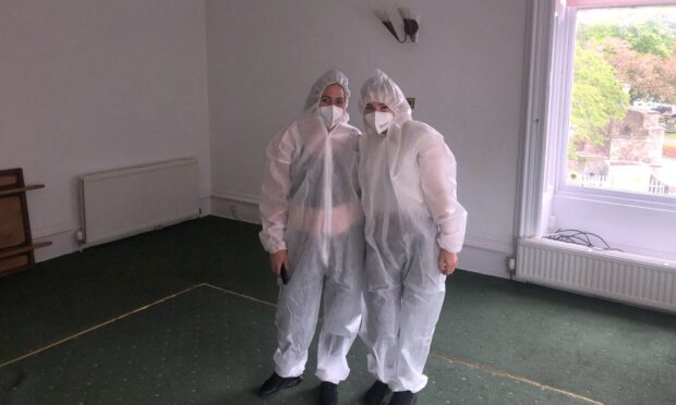 Gillian McIlravie and Sofia Anderson donned their white suits to do a cleaning job at the former Greenside Hotel in Leslie. Image: James Simpson/DC Thomson