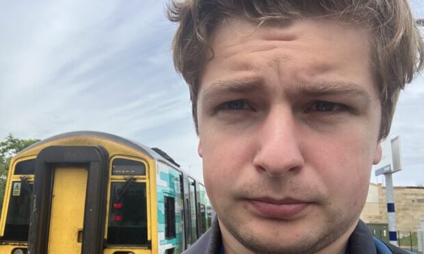 Finn Nixon boards a train for Edinburgh at Leven railway station.