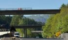 The lorry has crashed through a barrier on the M90 flyover and landed on the road below. Image: Lucy Scarlett/DC Thomson
