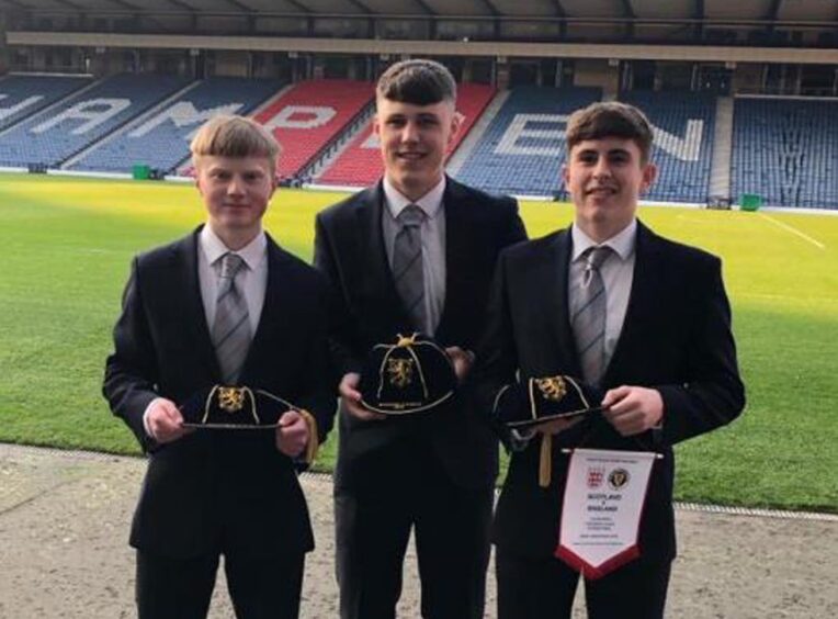 Josh Mulligan (centre) alongside Dundee team-mates Lyall Cameron and Fin Robertson at Hampden for a Scotland Schoolboys international cap ceremony. Image: Dundee FC