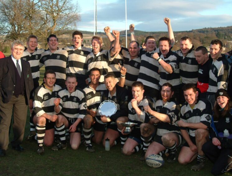 Perthshire players celebrating with the trophy.