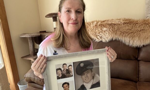 Paula Colville at her Lochgelly home holding photos of her Mafia-linked father.