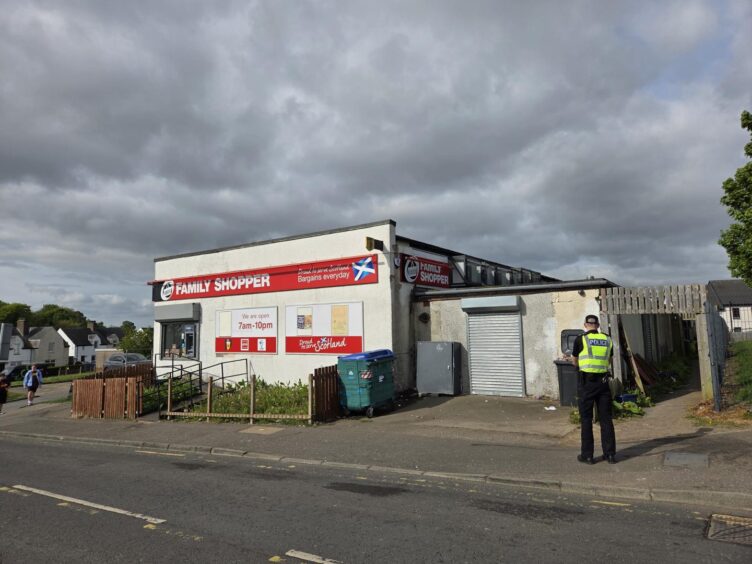 Police standing guard outside Dundee pub The Taverns on Monday morning. 
