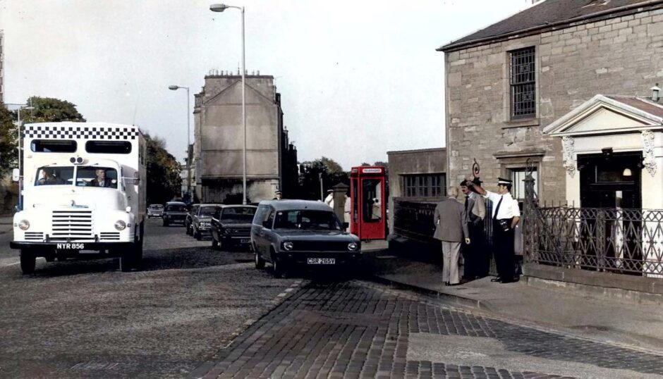 a police van on the street and officers on the scene at 2 Roseangle, Dundee, in May 1980.