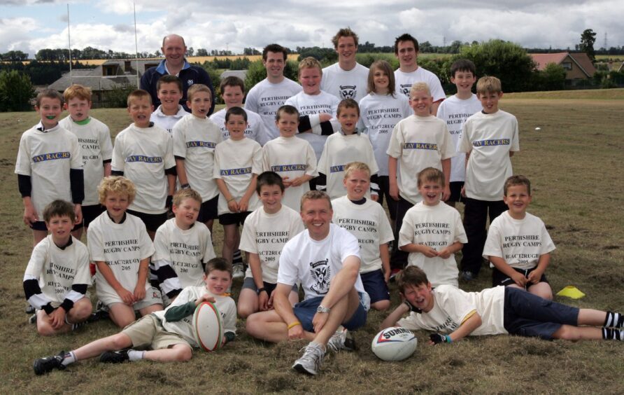 Organisers and youngsters pose for a picture at the rugby camp in August 2005. 