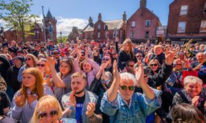 Thousands packed Kirrie Town Square beside the Peter Pan statue for Long Way to the Top. Image: Steve MacDougall/DC Thomson