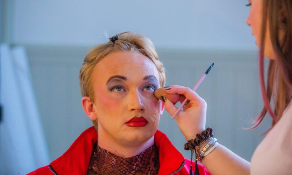 Make-up being applied to Robert Oakes' face