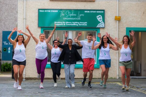 Group of people running outside premises of Stephen Lyon Organisation in Perth
