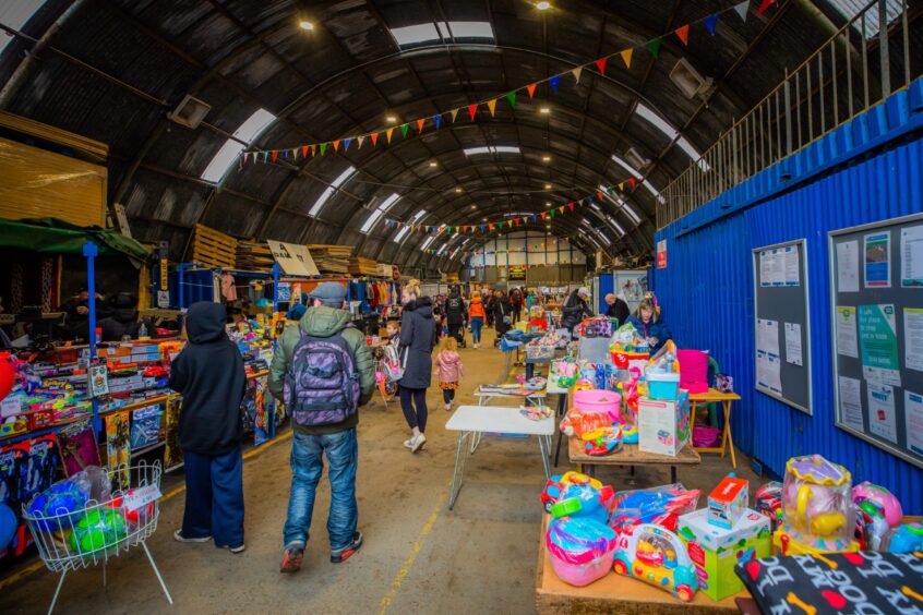 Errol Sundat market with stalls lines up around old aircraft hangar