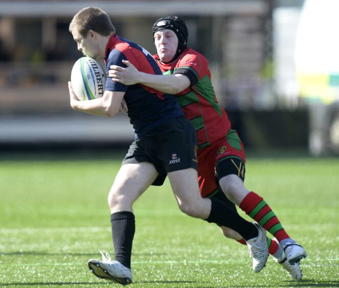 Glenrothes' Stewart Hainey is tackled by Darren MacLeod in April 2014.