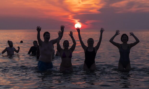 May Day Dippers on the East Sands in St Andrews, Fife. Image:  Jane Barlow/PA Wire