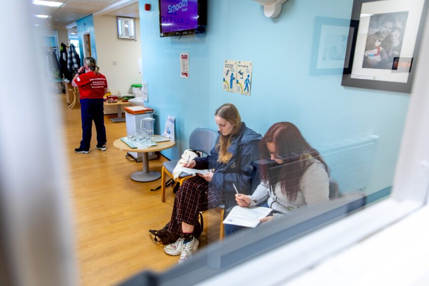 Donors Imogen Clark and Justyna Zonko, both Dundee, completing the pre-donation questionnaire at Dundee Blood Donor Centre in Ninewells Hospital. 