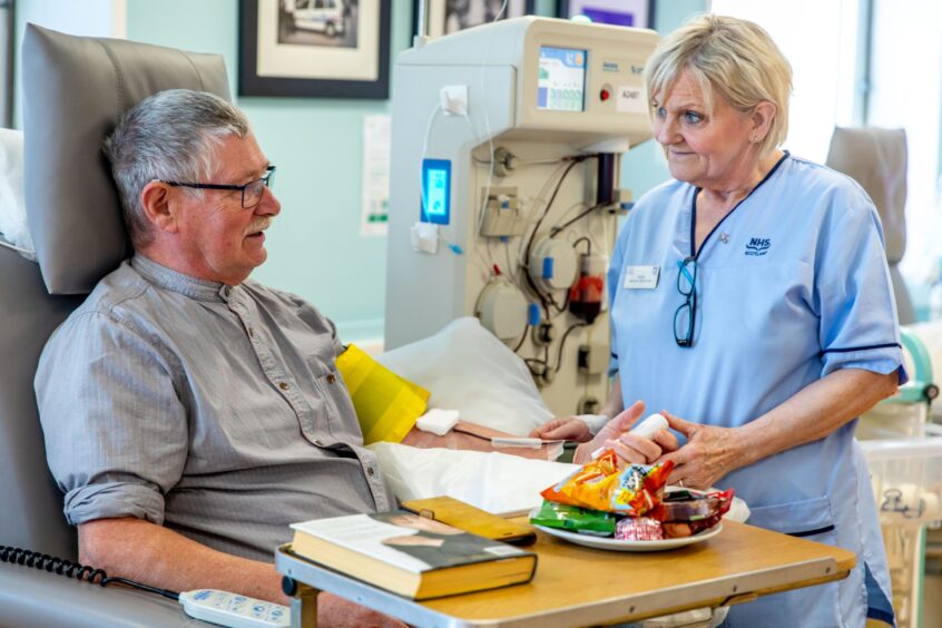 Ron Buist, 69, from Arbroath, donating plasma on the Aurora machine, watched over by Apheresis donor carer Angela at Dundee Blood Donor Centre in Ninewells Hospital.