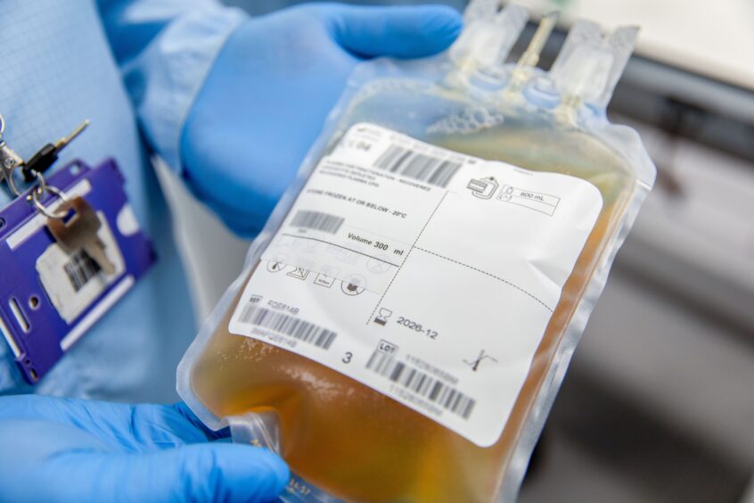 Plasma is weighed and volume placed on the label.