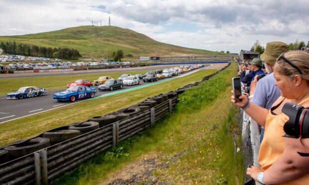 Racing fans enjoy the parade of 70's & Classic Cars during the 50th anniversary celebrations. Image: Steve Brown/DC Thomson