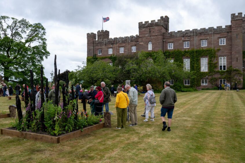 People looking at display on lawn in front of Scone Palace