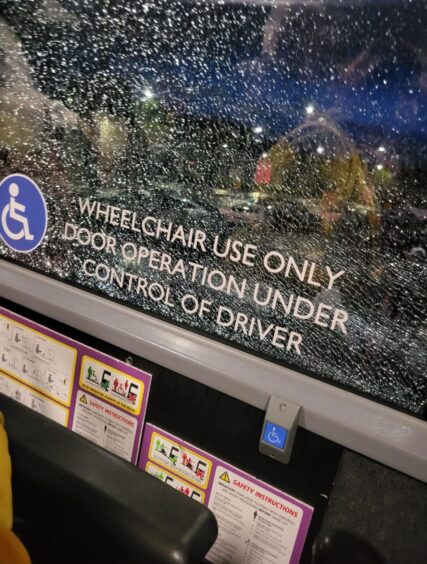 The broken window on the Fly bus service.