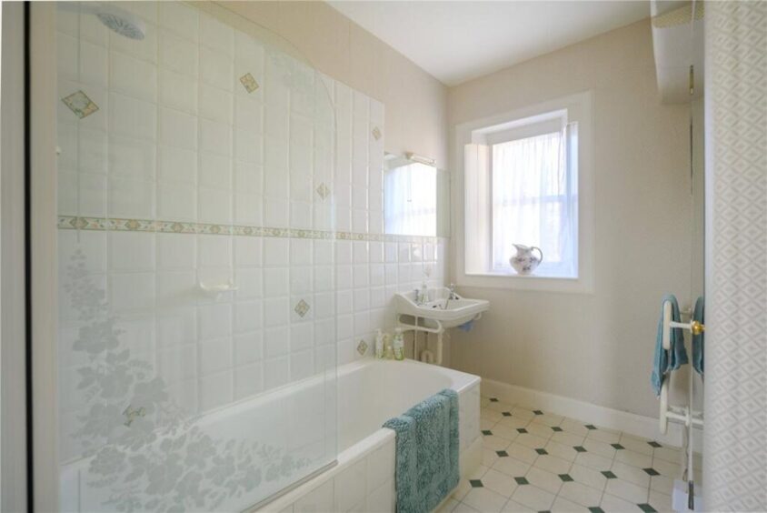 An ensuite bathroom sits off the master. 