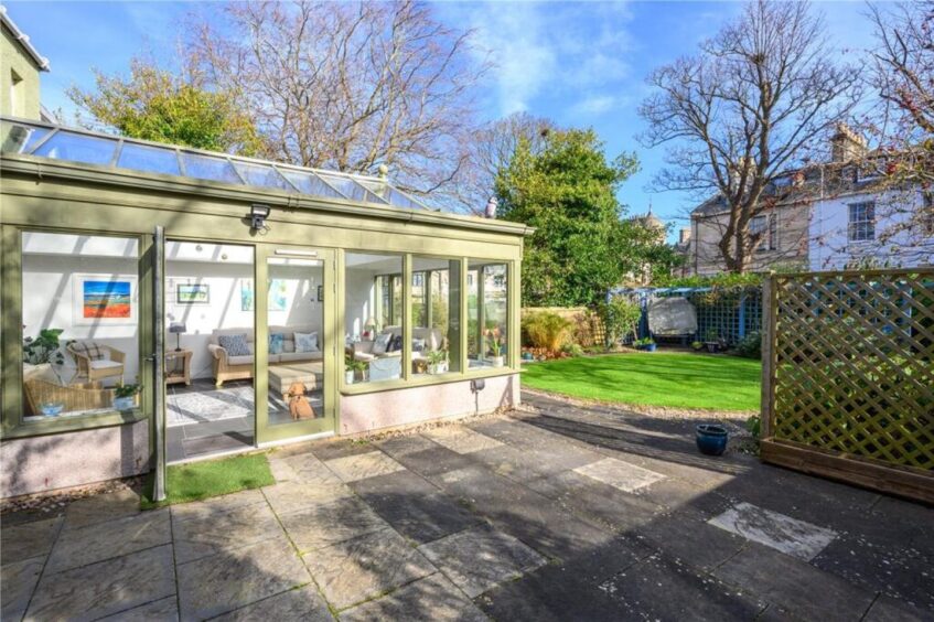The conservatory leads out onto the paved terrace. 